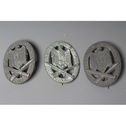 403 - THREE GERMAN THIRD REICH ASSAULT BADGES, comprising one by JFS with inset mounting for the pin and h... 