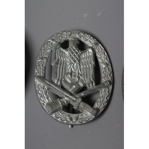 403 - THREE GERMAN THIRD REICH ASSAULT BADGES, comprising one by JFS with inset mounting for the pin and h... 