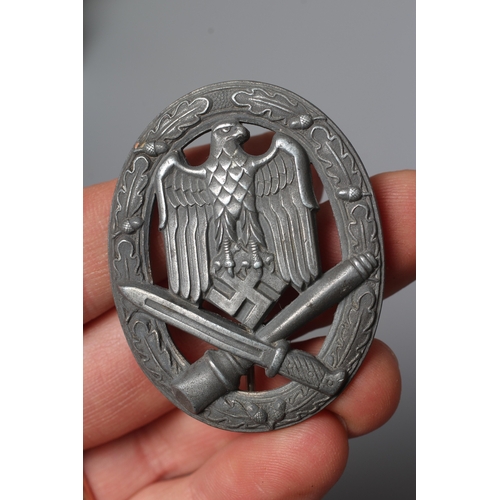 403 - THREE GERMAN THIRD REICH ASSAULT BADGES, comprising one by JFS with inset mounting for the pin and h... 