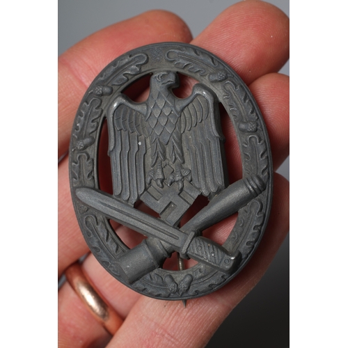 403 - THREE GERMAN THIRD REICH ASSAULT BADGES, comprising one by JFS with inset mounting for the pin and h... 