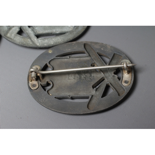 403 - THREE GERMAN THIRD REICH ASSAULT BADGES, comprising one by JFS with inset mounting for the pin and h... 