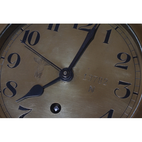 407 - A GERMAN THIRD REICH KRIEGSMARINE BRASS WALL CLOCK of bulkhead design with key opening door, brass f... 
