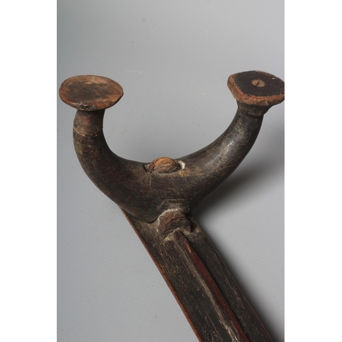 416 - AN ANTIQUE SOUTH SEA ISLAND KALI, possibly Tongan, with bowed central beam, raised on four carved le... 