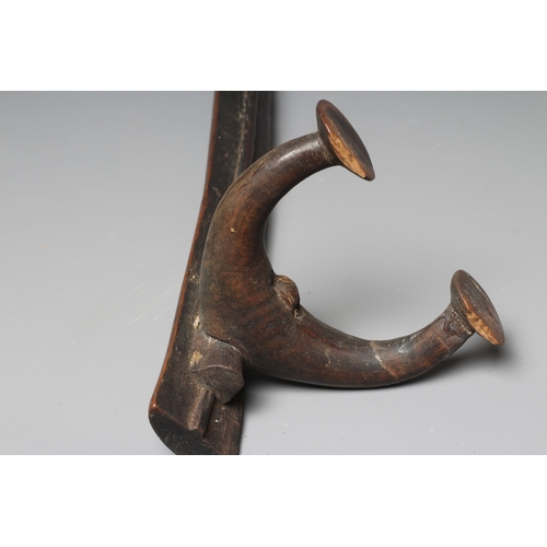 416 - AN ANTIQUE SOUTH SEA ISLAND KALI, possibly Tongan, with bowed central beam, raised on four carved le... 