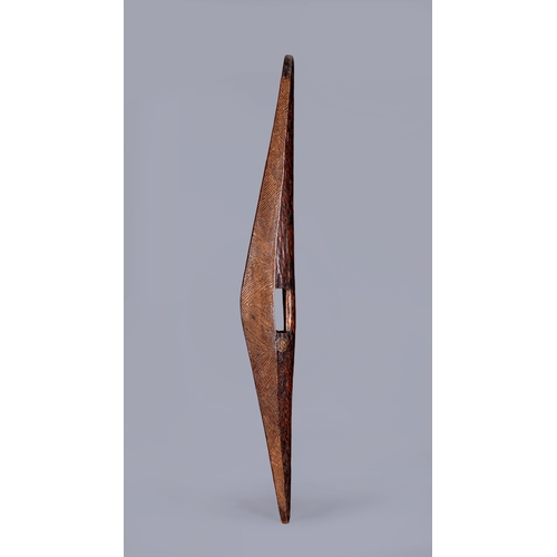417 - AN ANTIQUE ABORIGINAL PARRYING SHIELD of carved asymmetrical diamond form, with chevron carved front... 