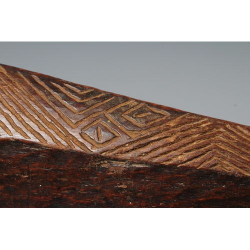 417 - AN ANTIQUE ABORIGINAL PARRYING SHIELD of carved asymmetrical diamond form, with chevron carved front... 