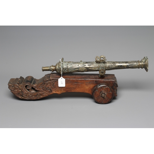 425 - A INDONESIAN BRONZE LANTAKA CANNON with flared muzzle, twin dolphin mounts, scroll rear sight, and f... 