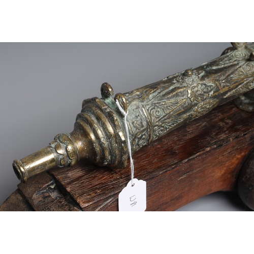 425 - A INDONESIAN BRONZE LANTAKA CANNON with flared muzzle, twin dolphin mounts, scroll rear sight, and f... 
