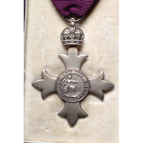 438 - A SILVER OBE, London 1919, Garrard & Co. Ltd, with purple ribbon, cased