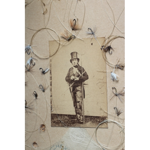 452 - A VICTORIAN FRAMED FISHING DISPLAY centred by a photograph of a gentleman in tails, top hat and fish... 