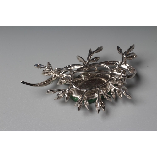 277 - A DIAMOND AND JADE FLOWER SPRAY BROOCH, the central quatrefoil jade panel incise carved and dot pier... 