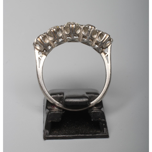 282 - A FIVE STONE DIAMOND RING, the central brilliant cut stone of approximately 0.5cts flanked by four s... 