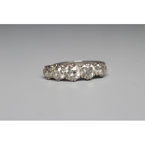 282 - A FIVE STONE DIAMOND RING, the central brilliant cut stone of approximately 0.5cts flanked by four s... 