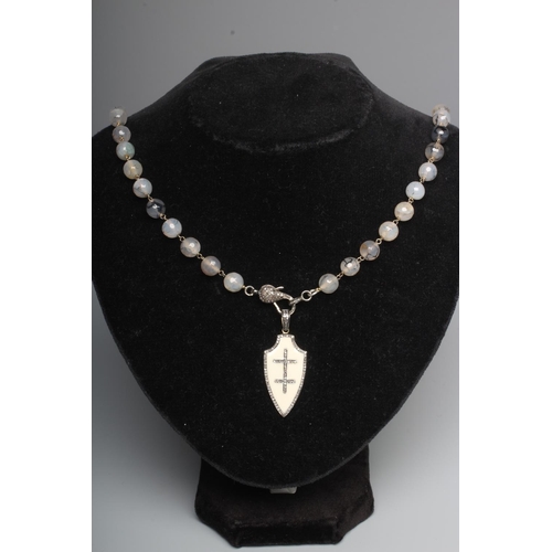 283 - A STRING OF FACET CUT MOSS AGATE BEADS, the pave set diamond lobster clasp with a cream enamel amd d... 
