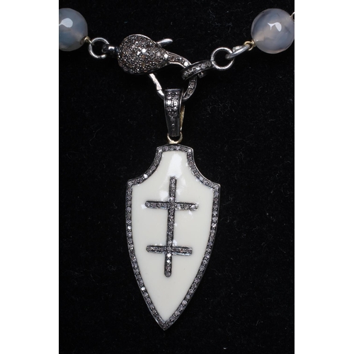 283 - A STRING OF FACET CUT MOSS AGATE BEADS, the pave set diamond lobster clasp with a cream enamel amd d... 