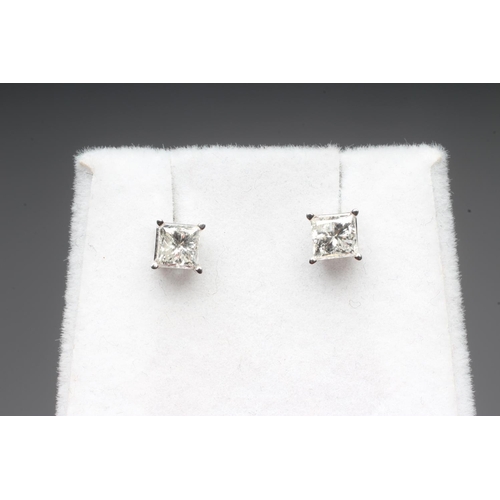 284 - A PAIR OF PRINCESS CUT SOLITAIRE DIAMOND EAR STUDS on 14k white gold posts with butterflies, with ce... 