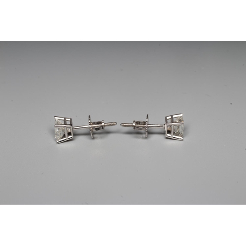 284 - A PAIR OF PRINCESS CUT SOLITAIRE DIAMOND EAR STUDS on 14k white gold posts with butterflies, with ce... 