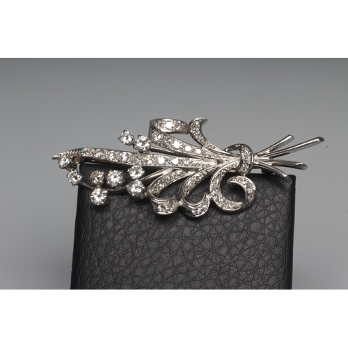 287 - A DIAMOND SPRAY BROOCH, the numerous brilliant cut stones claw and pave set to a white frame, applie... 