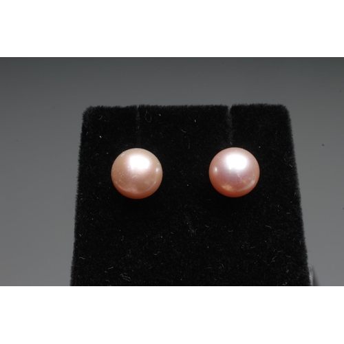 288 - A PAIR OF CULTURED PEARL EAR STUDS, the pale pink peg set pearls on 9ct white gold posts with butter... 