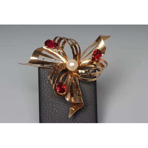 290 - A RUBY AND PEARL ABSTRACT FLOWERHEAD BROOCH, the pierced scroll petals and leaves claw set with thre... 