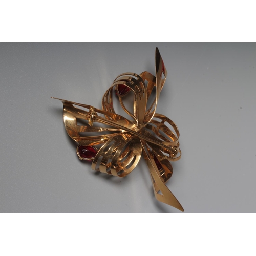 290 - A RUBY AND PEARL ABSTRACT FLOWERHEAD BROOCH, the pierced scroll petals and leaves claw set with thre... 
