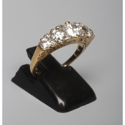 291 - A FIVE STONE DIAMOND RING, the central brilliant cut stone of approximately 0.7cts claw set and flan... 