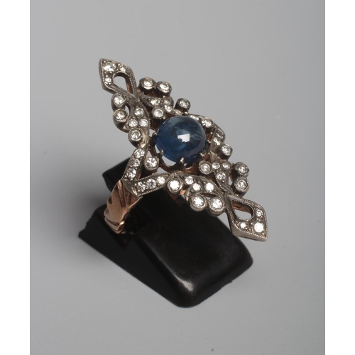 296 - A GEORGIAN STYLE MARQUISE DRESS RING, the central cabochon polished circular sapphire claw set to an... 