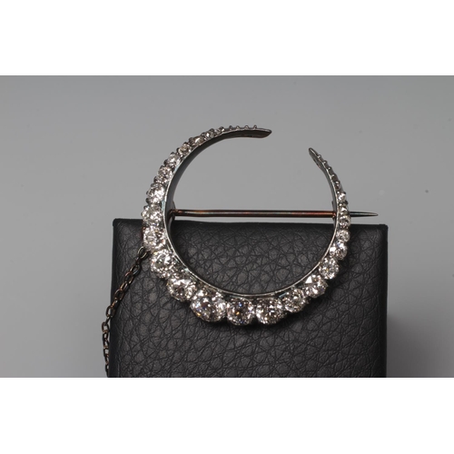 297 - A DIAMOND CRESCENT BROOCH, the seventeen old brilliant and four rose cut graduated stones claw set t... 