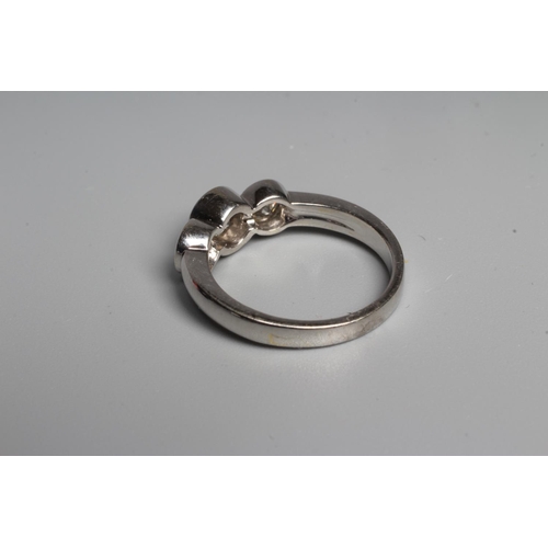 299 - A THREE STONE DIAMOND RING, the central round brilliant cut stone open back collet set and flanked b... 