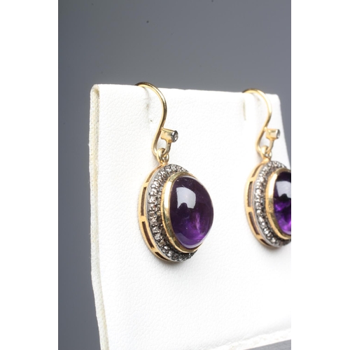 301 - A PAIR OF AMETHYST AND DIAMOND DROP EARRINGS, the oval cabochon polished amethysts open back collet ... 