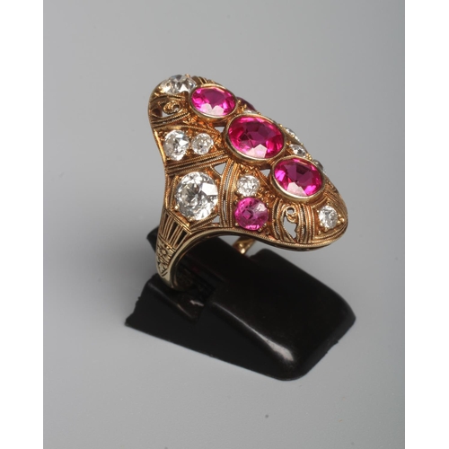 304 - A RUBY AND DIAMOND COCKTAIL RING, the domed oval panel centred by three facet cut rubies collet set ... 