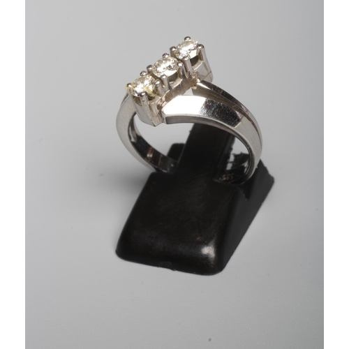305 - A THREE STONE DIAMOND RING, the brilliant cut stones each of approximately 0.10cts, point set in a s... 