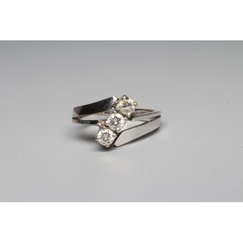 305 - A THREE STONE DIAMOND RING, the brilliant cut stones each of approximately 0.10cts, point set in a s... 