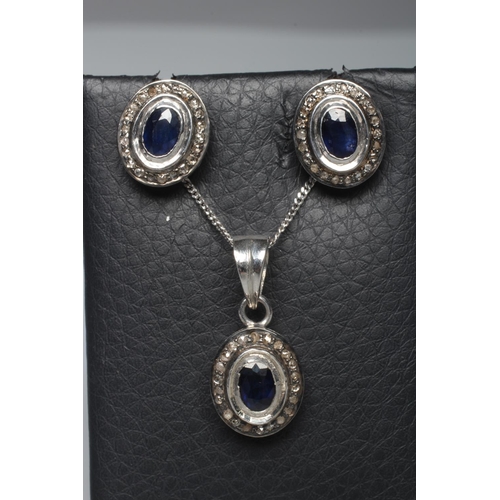 306 - A SAPPHIRE AND DIAMOND SUITE, comprising pendant on chain and a pair of ear studs, each with a centr... 