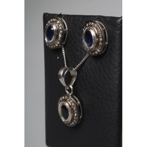 306 - A SAPPHIRE AND DIAMOND SUITE, comprising pendant on chain and a pair of ear studs, each with a centr... 