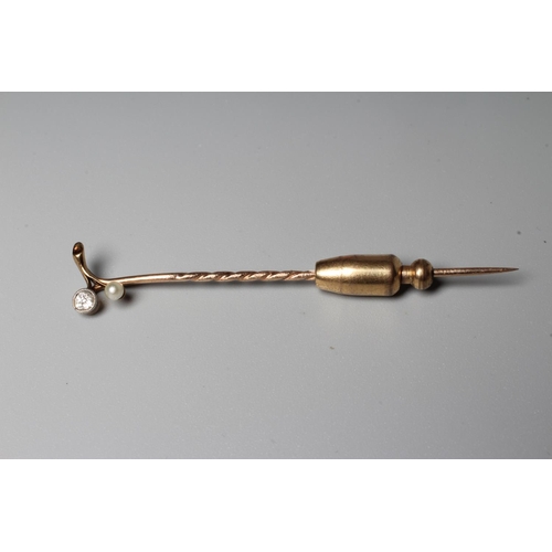 307 - A VICTORIAN DIAMOND AND PEARL STICK PIN, the brilliant cut diamond collet set with a peg set small p... 
