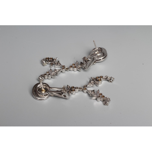 312 - A PAIR OF DIAMOND CHANDELIER EARRINGS, the target cluster hung with a double pendant husk drop to un... 
