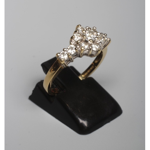 315 - A DIAMOND CLUSTER RING, the central seven stone cluster claw set to shoulders each further set with ... 
