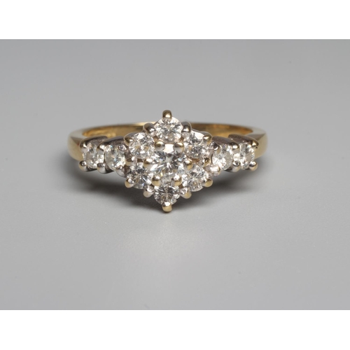 315 - A DIAMOND CLUSTER RING, the central seven stone cluster claw set to shoulders each further set with ... 