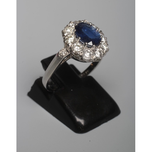 316 - A SAPPHIRE AND DIAMOND CLUSTER RING, the oval facet cut sapphire of approximately 1.50cts, claw set ... 