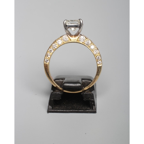 317 - A DIAMOND RING, the central Princess cut stone of approximately 1ct, claw set to shoulders each pave... 