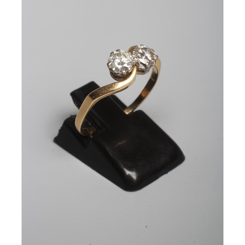 318 - A TWO STONE DIAMOND CROSSOVER RING, the brilliant cut stones each of approximately 0.40cts, claw set... 