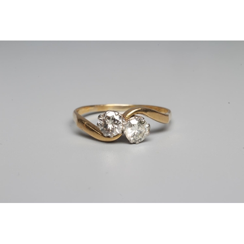 318 - A TWO STONE DIAMOND CROSSOVER RING, the brilliant cut stones each of approximately 0.40cts, claw set... 