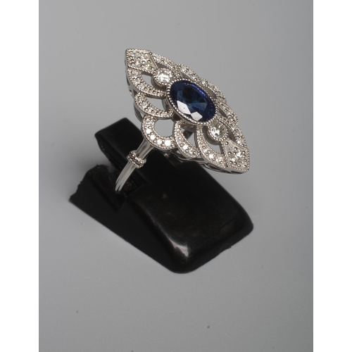 319 - AN EDWARDIAN STYLE SAPPHIRE AND DIAMOND DRESS RING, the central oval facet cut sapphire open back co... 