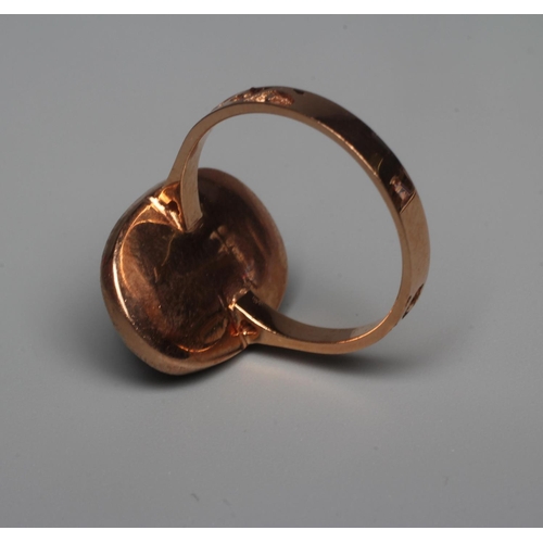 324 - A SAPPHIRE AND DIAMOND DRESS RING, the central oval facet cut sapphire within a border of twelve rou... 