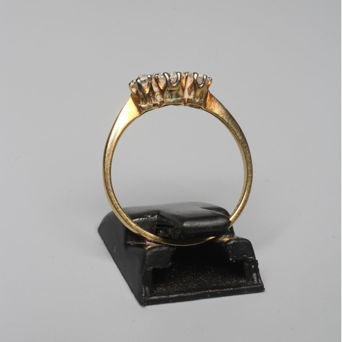 328 - A THREE STONE DIAMOND RING, the graduated stones claw set to a plain shank, indistinctly stamped 18c... 
