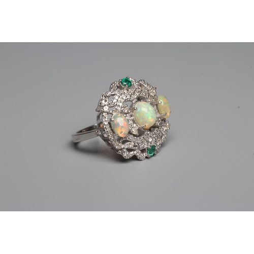329 - A THREE STONE OPAL DRESS RING, the oval cabochon polished stones claw set to a fancy open frame set ... 