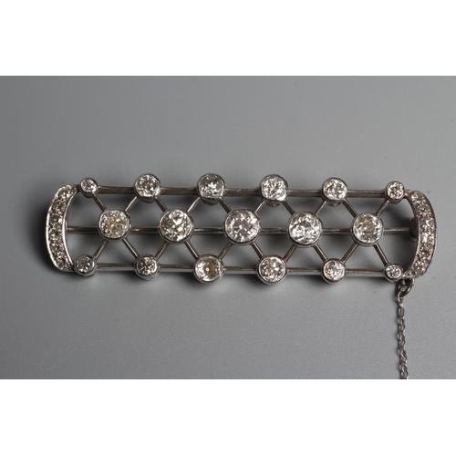 345 - AN ART DECO DIAMOND BROOCH of D end oblong form centred by a lattice with seventeen diamonds collet ... 