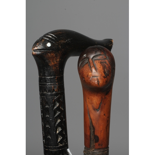 380 - TW0 ANGLO INDIAN SWORD STICKS, one possibly 19th century with carved monkey head grip and 29 1/4
