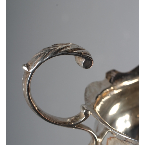 148 - A GEORGE II SILVER SAUCEBOAT by Andrew Killick, London 1751, the oval bowl with everted cut rim, aca... 